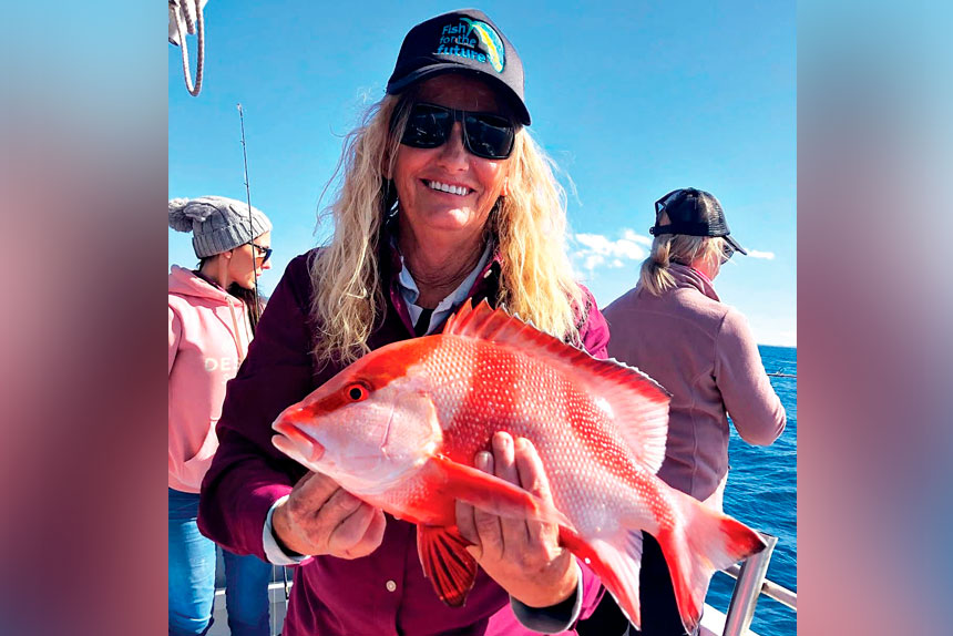 RED HOT: Sam Beckmann of 2 Bent Rods with a red throat emperor caught off a local charter.