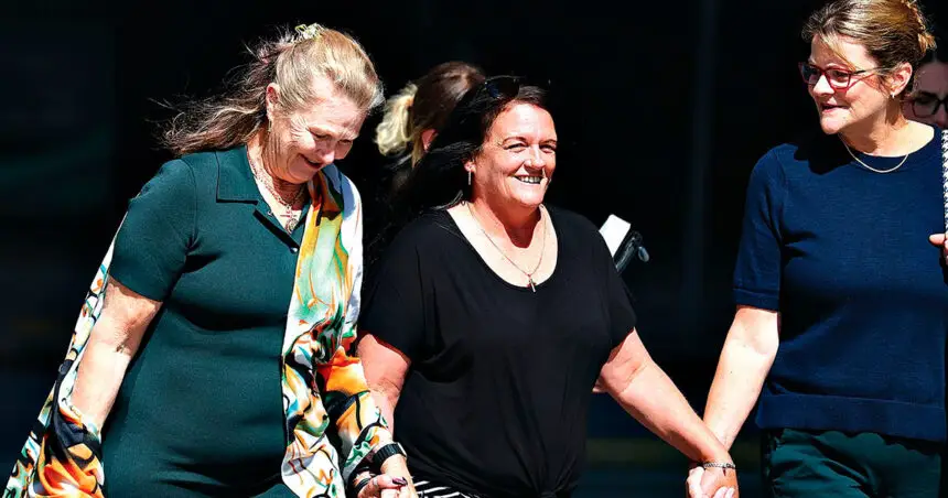 Kylie Ellina Truswell-Mobbs, centre, arrives at the court.(AAP Image/Jason O’Brien)