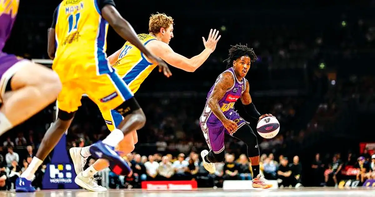 ON THE DRIVE: Sydney Kings star Kendric Davis dribbles past Brisbane Bullets defenders. PHOTOS: NBL.COM