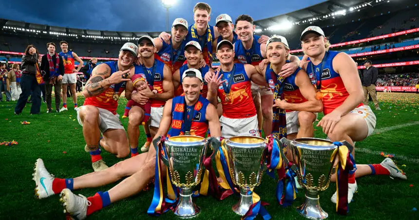 Brisbane Lions players celebrate with their three premiership cups following their 2026 AFL Grand Final win over the Fremantle Dockers. (AAP Image/Joel Carrett)