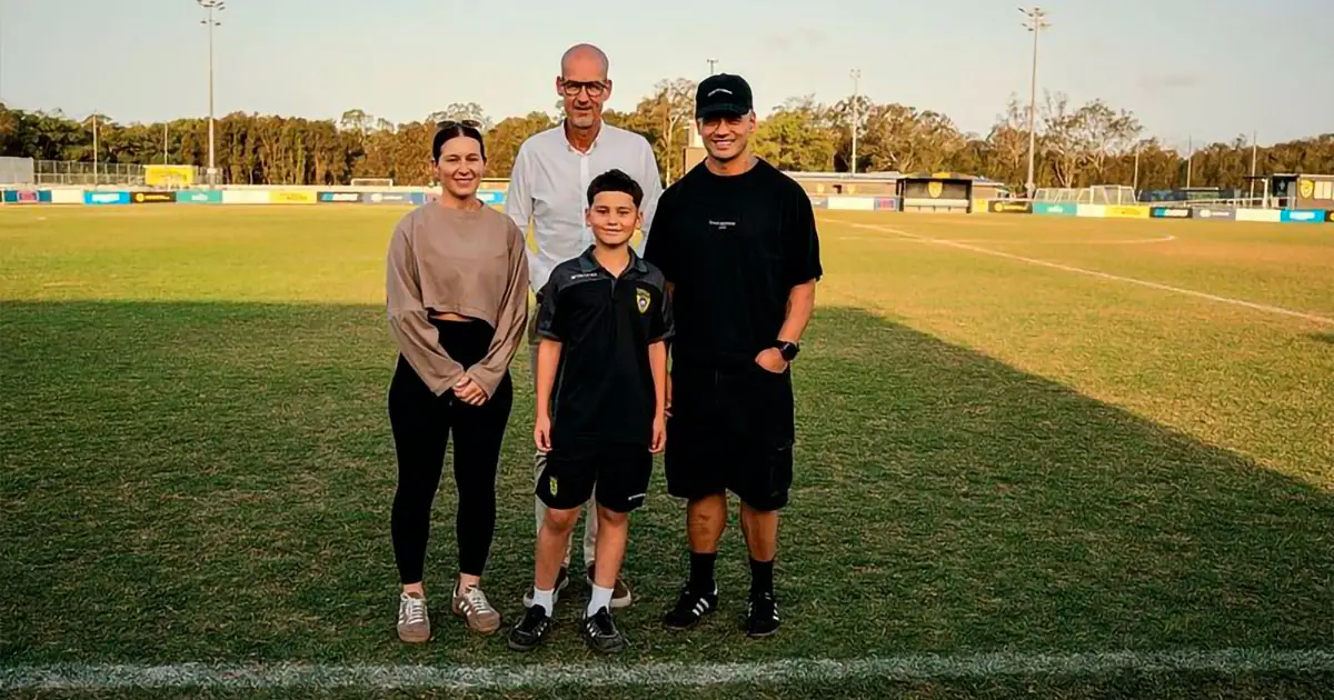 Xavian Petelo and his parents with Borussia Dortmund managing director Carsten Cramer.